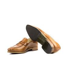 Load image into Gallery viewer, Underside view of luxurious cognac penny loafers highlighting the sturdy forest green leather sole with a protective black rubber insert for grip.