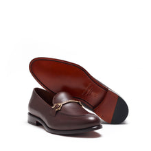 Load image into Gallery viewer, A single dark brown calf leather horsebit loafer angled to show the cognac leather sole, with its luxurious finish and understated elegance.