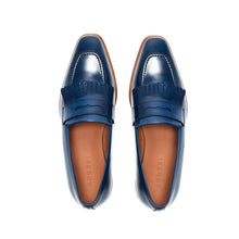 Load image into Gallery viewer, Overhead view of navy blue penny loafers with fringe, revealing the meticulous stitching and the classic penny slot on a white surface.