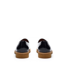 Load image into Gallery viewer, Back view of glossy patent black belgian loafers highlighting the sturdy heel construction with a tan sole, contrast stitching, and a polished finish.