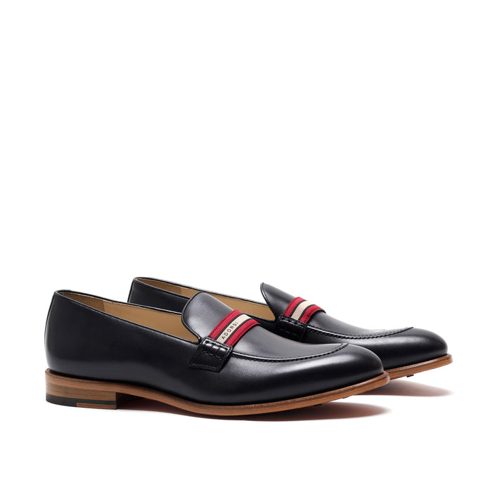 Elegant black calf leather loafers with a distinctive web stripe design, showcasing a sleek frontal view on a white background.