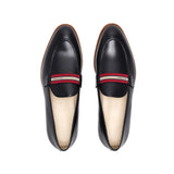 Top-down view of luxurious black calf loafers with a web stripe band, highlighting the meticulous stitching and craftsmanship on a white surface.