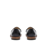 Back perspective of sophisticated black calf loafers, emphasizing the heel design and leather sole, set against a white background.