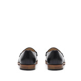 Back perspective of sophisticated black calf loafers, emphasizing the heel design and leather sole, set against a white background.