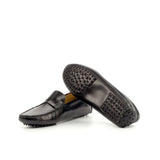 An image displaying the unique pebbled sole of a black nappa leather penny driving loafer, highlighting the rubber nubs for grip and comfort.