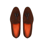 Overhead image capturing the intricate stitching and layered kiltie tassel design of the brown suede loafers.
