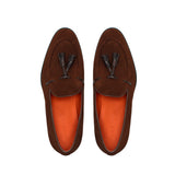 Overhead image capturing the intricate stitching and layered kiltie tassel design of the brown suede loafers.