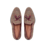 Top-down view of brown tweed tassel loafers, detailing the checkered pattern and complementing tassel embellishments.