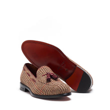 Load image into Gallery viewer, Angled view of the loafers with focus on the polished cognac leather insole and the robust black outsole with a grip pattern.

