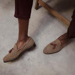 Lifestyle image featuring a person wearing brown tweed tassel loafers, perfectly paired with burgundy trousers for a smart-casual look.