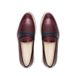 Overhead image of the loafers displaying the fine grain texture of the burgundy leather and the navy penny keeper strap.