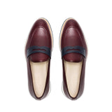 Overhead image of the loafers displaying the fine grain texture of the burgundy leather and the navy penny keeper strap.