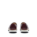 Back angle of the loafers highlighting the dark heel counter and the gentle slope of the shoe's back, all above a sturdy chunky sole.