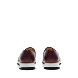 Back angle of the loafers highlighting the dark heel counter and the gentle slope of the shoe's back, all above a sturdy chunky sole.