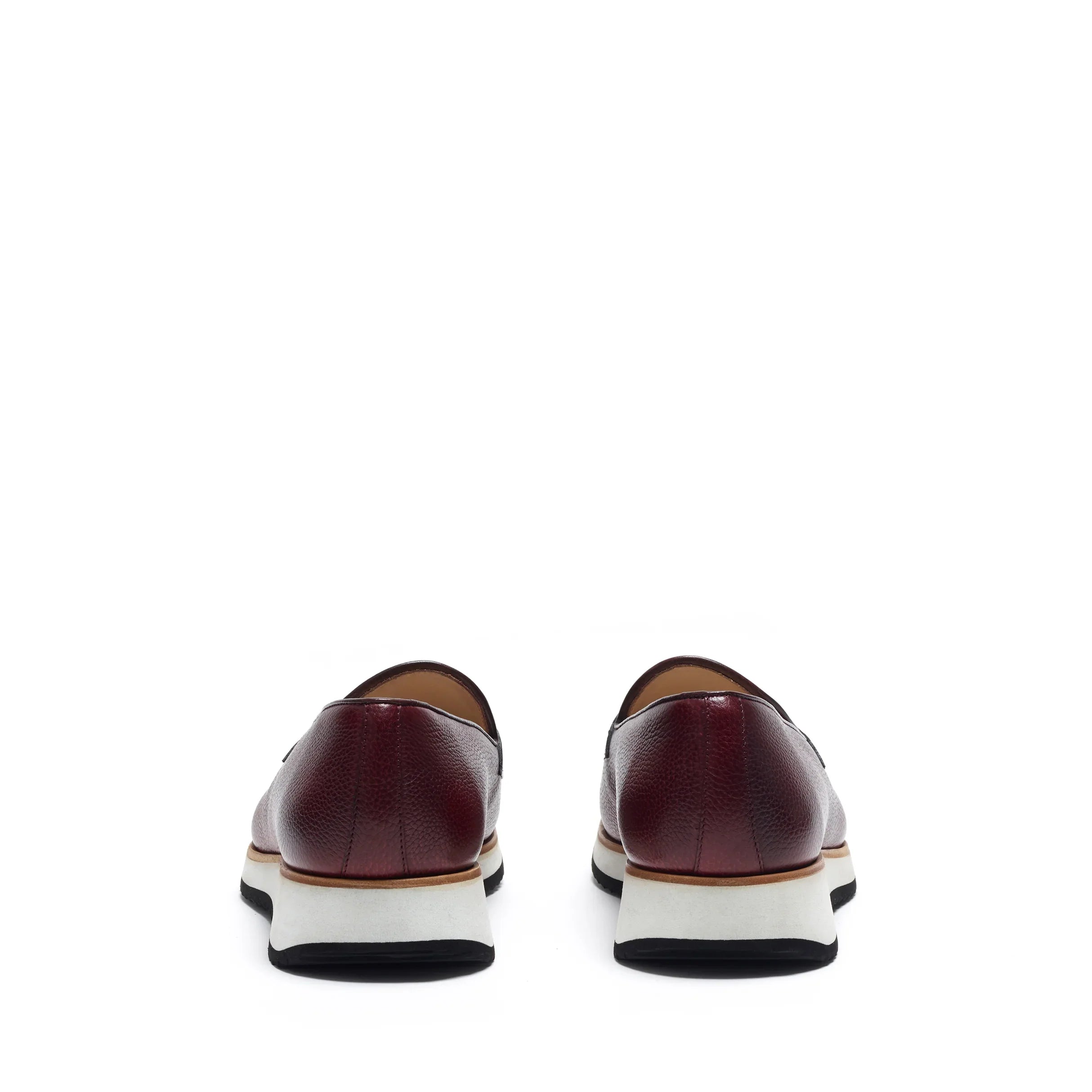 Back angle of the loafers highlighting the dark heel counter and the gentle slope of the shoe's back, all above a sturdy chunky sole.