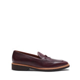 Side profile of the burgundy pebble grain loafers showing the textured leather and slim silhouette, set on a white backdrop.