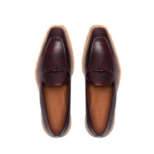 Load image into Gallery viewer, Top-down image of the loafers highlighting the grainy texture of the leather and the classic loafer bow on a white surface.
