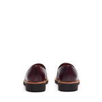 Back angle of the loafers, focusing on the stitching details and the contrast of the burgundy leather and brown heel.