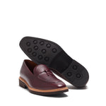 Angled view that showcases the sturdy brown rubber sole for grip, complementing the pebble grain leather upper.