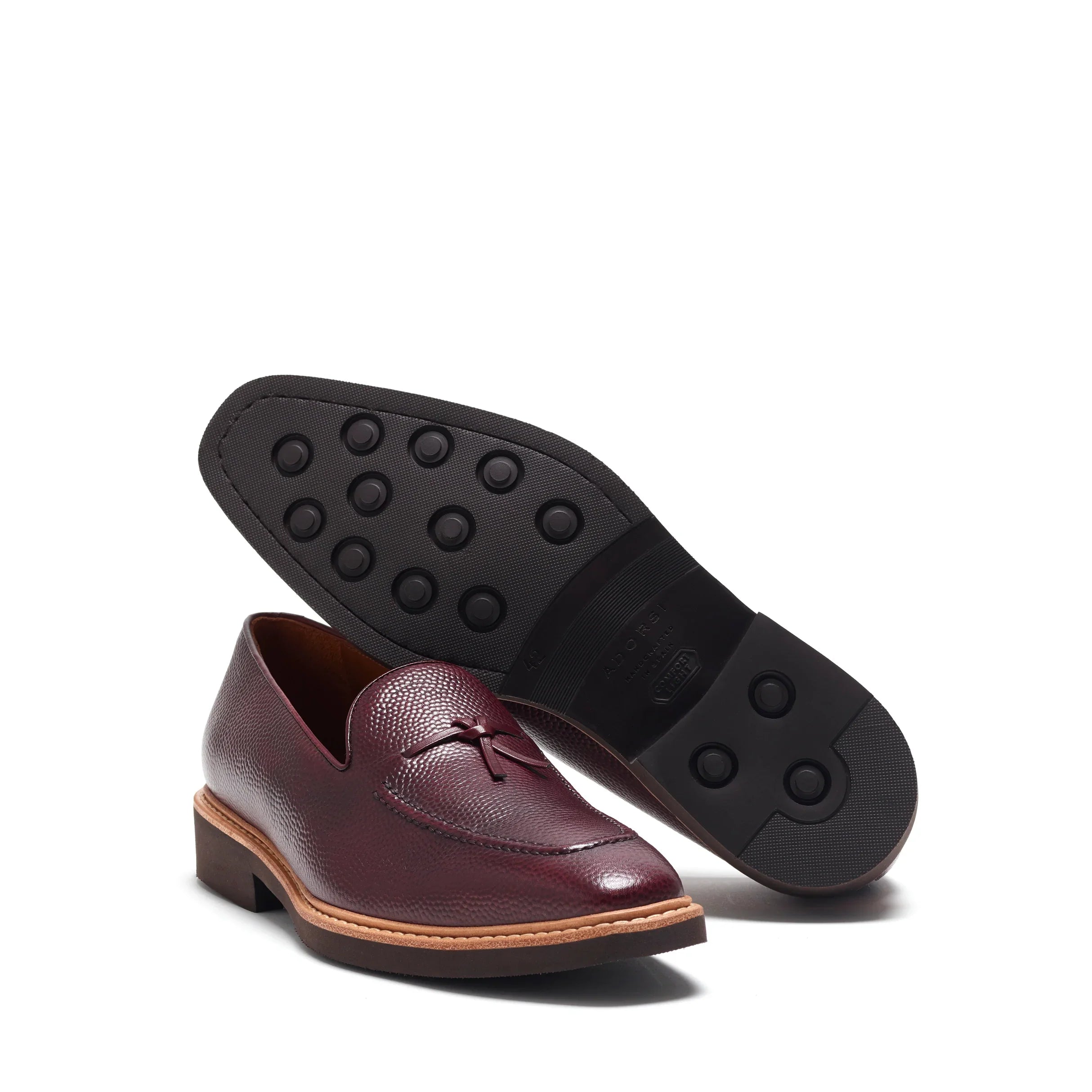 Angled view that showcases the sturdy brown rubber sole for grip, complementing the pebble grain leather upper.