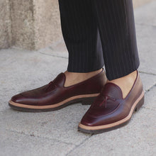 Load image into Gallery viewer, Stylish lifestyle shot of a person wearing the burgundy Belgian loafers, paired with pinstripe trousers for a classic and professional look.
