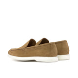 Profile view of camel suede casual loafers showing the side stitching details and the soft curves of the design, against a clean white backdrop.