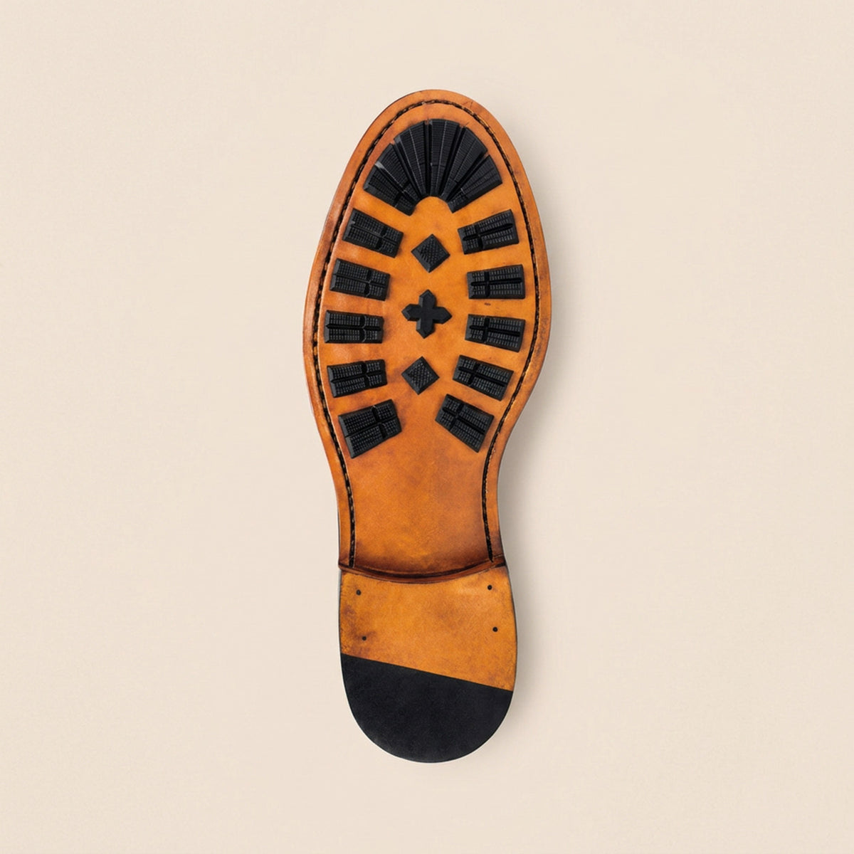 Goodyear-welted leather soles with rubber “mountains”