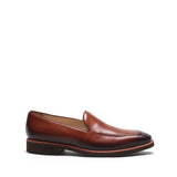 Side view of a single burnished medium brown calf plain loafer highlighting the smooth finish and classic design, against a stark white backdrop.