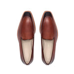 Top view of burnished medium brown calf plain loafers showing the Squared toe and flawless finish, presented on a white surface.