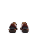 Rear view of burnished medium brown calf plain loafers emphasizing the darkened heel counter and clean lines, on a white background.