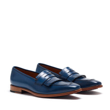 Load image into Gallery viewer, A pair of navy calf fringe penny loafers with a polished finish and detailed fringe on the vamp, presented on a white background.
