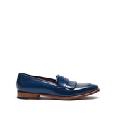 Side view of a glossy navy penny loafer with fringe detailing, showcasing the sleek design and natural brown sole.