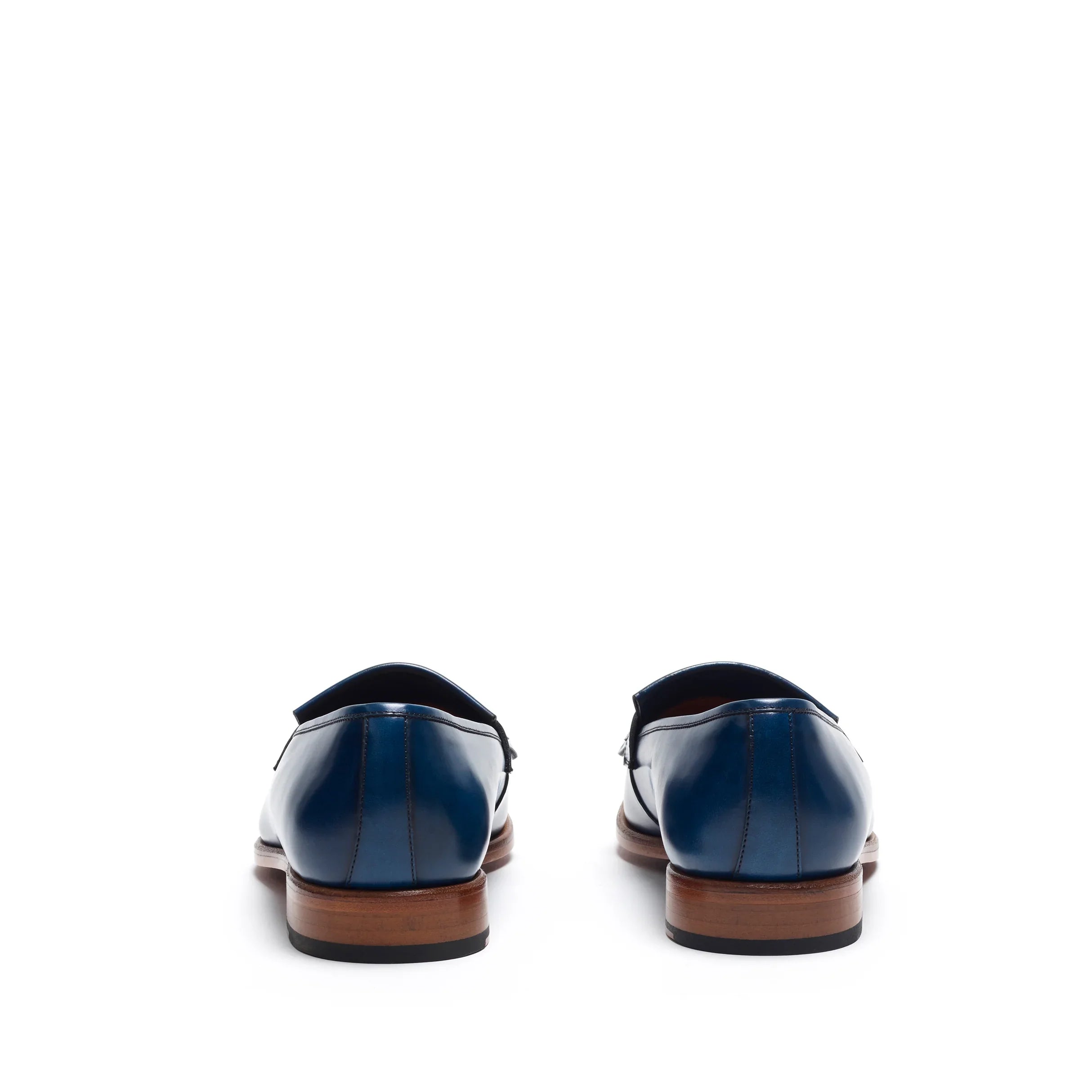 Back perspective of the navy fringe loafers, focusing on the heel counter and the clean lines of the shoe's design.