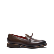 Load image into Gallery viewer, This side profile showcases the olive-green leather loafers with a distinctive lace-up design, accentuating the refined stitching and the elegant contours of the footwear.
