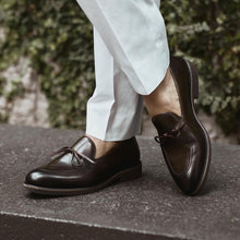 Load image into Gallery viewer, Lifestyle image of olive calf laced loafers worn with light-colored trousers, providing a sophisticated look suitable for both casual and formal attire.
