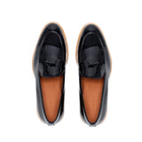 Top view of patent black Belgian loafers, showcasing the classic loafer design with a bow tie on the vamp and flawless glossy finish.
