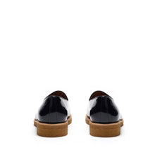 Load image into Gallery viewer, Back view of glossy patent black belgian loafers highlighting the sturdy heel construction with a tan sole, contrast stitching, and a polished finish.

