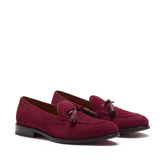 Elegant wine-colored suede loafers featuring a contrasting burgundy laced tassel leather, set against a white background, showcasing the sleek design and rounded toe.