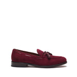 Side view of a wine suede laced tassel loafer highlighting the low heel and the intricate stitching around the vamp.