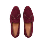 An overhead view showcasing the deep wine suede upper of the loafers, complemented by the burgundy calf leather laced tassels, creating a refined aesthetic.