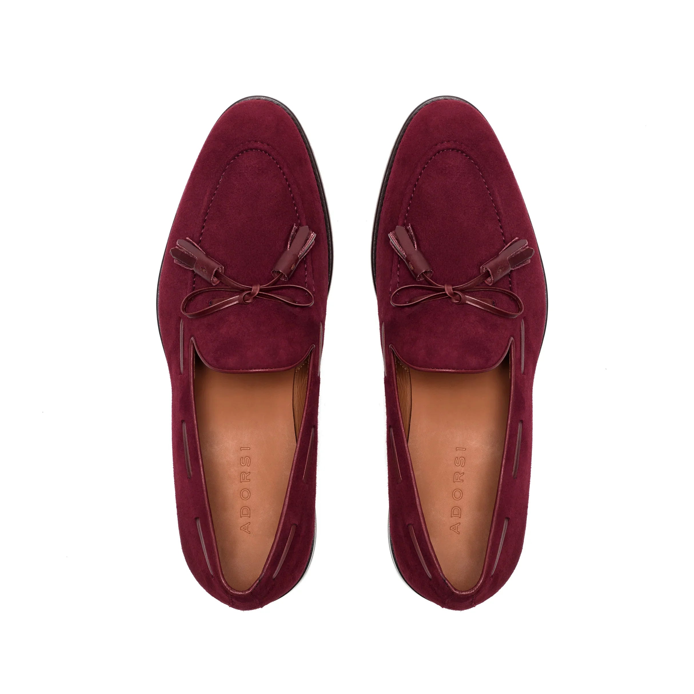 An overhead view showcasing the deep wine suede upper of the loafers, complemented by the burgundy calf leather laced tassels, creating a refined aesthetic.