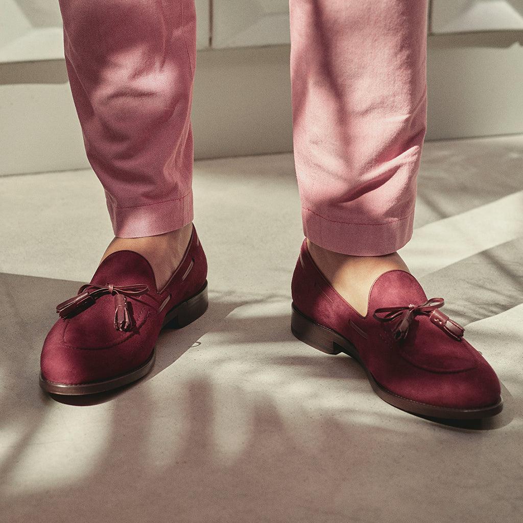 The loafers worn in a lifestyle setting, accentuating the laced tassel detail and showcasing how they complement a casual, chic style.