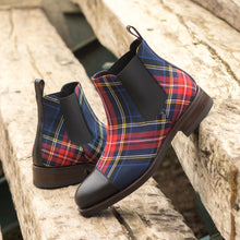 Load image into Gallery viewer, A pair of ADORSI Black Calf &amp; Tartan Chelsea Boots on a wooden bench.
